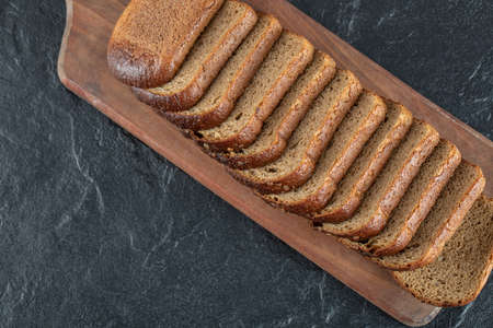 A wooden cutting board with slices of bread