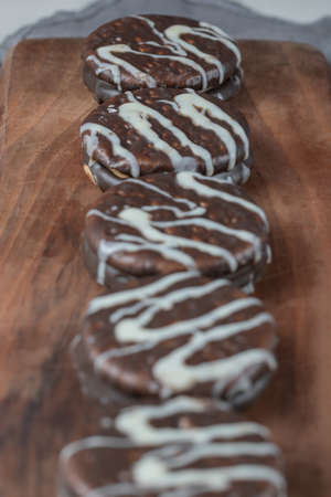 Chocolate cookies with white decoration on it