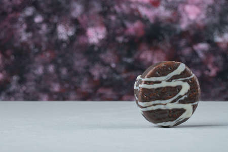 Chocolate cookies with white decoration on it