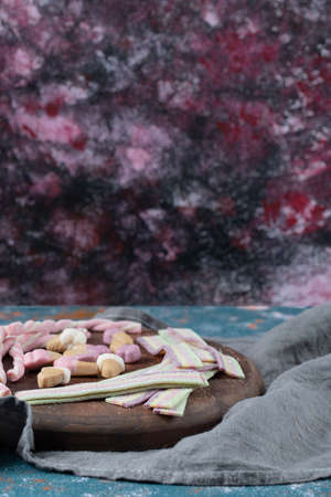 Rainbow narrow long jellybeans on a wooden board