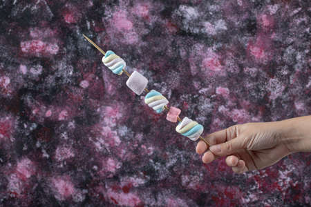 Colorful marshmallows on the wooden sticks for grilling. High quality photo
