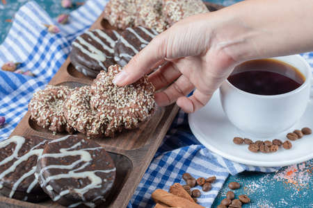 A cup of coffee served with chocolate cookies. High quality photoの写真素材