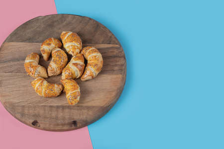 Fried caucasian mutaki cookies on a wooden board on pink blue backgroundの写真素材