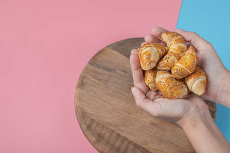 Fried caucasian mutaki cookies on a wooden board on pink blue background