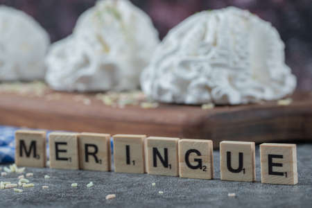 Meringue writing with letter dices around cookies. High quality photoの写真素材