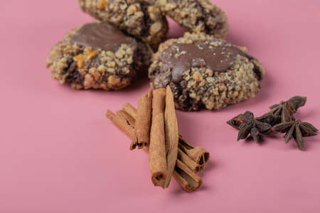Crocante chocolate cookies with cinnamon and anise on a pink background