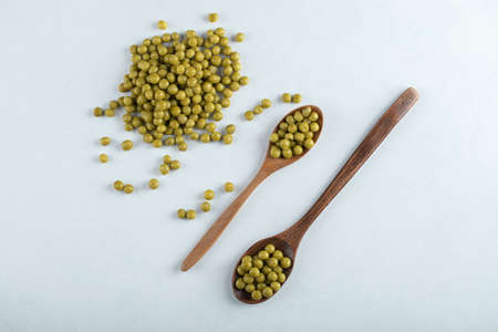 Two spoon olive and pile of marinated olivesの写真素材