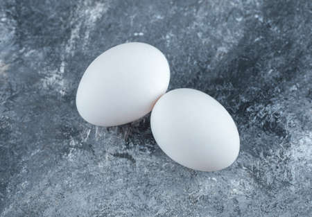 Close up photo of two fresh chicken eggsの写真素材