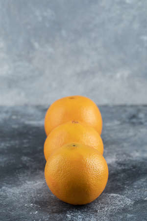 Three tasty oranges on marble backgroundの写真素材