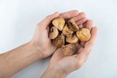 Dried tasty figs around wooden plateの写真素材