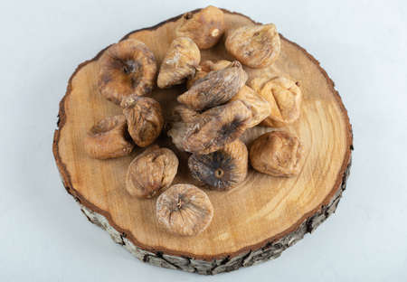 Organic dried figs on wood piece