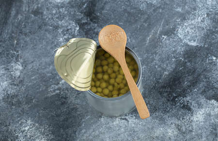 Close up photo of opened tin and wooden spoon