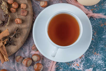 Chocolate cookies with nuts, cinnamon and anise served with a cup of teaの写真素材