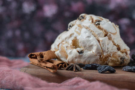 Fluffy meringue muffins with black dry grapes on the tableの写真素材
