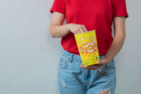 A model holding a box of popcornsの写真素材