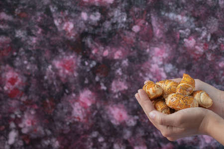 Holding caucasian mutaki cookies in the hand