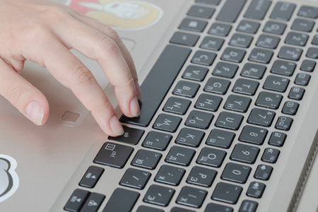 Employee working at grey laptop in the office
