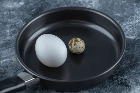 Close up photo of Fresh organic chicken egg with quail eggsの写真素材