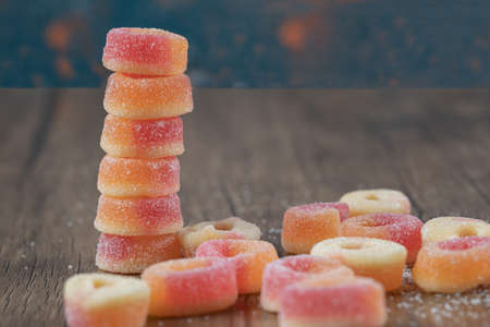 Redish circle jellybeans on a wooden tableの写真素材