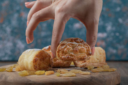 Crispy cooked roll cookies with stuffing on a wooden boardの写真素材