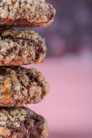 Chocolate crocante cookies with nuts on a pink backgroundの写真素材
