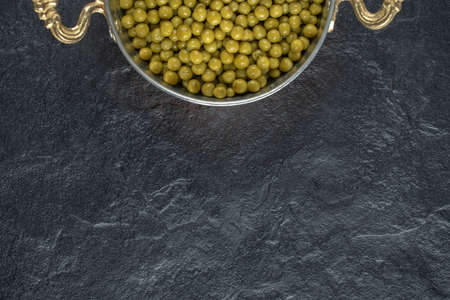 Close up photo of marinated green olives over black backgroundの写真素材