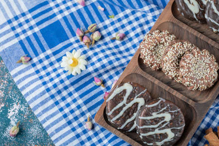 Chocolate and sesame cookies on a wooden platterの写真素材