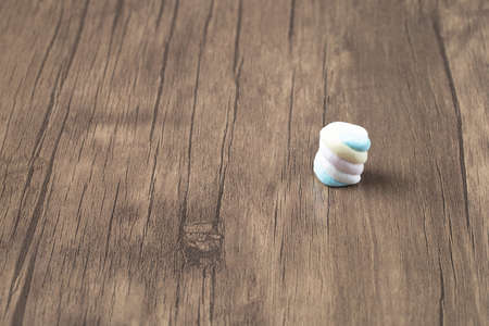 Pink blue spiral shape rainbow marshmallows on the groundの写真素材