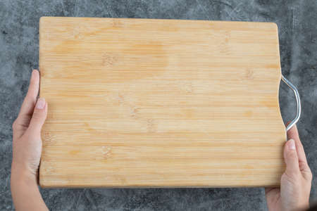 A wooden cutting board on the backgroundの写真素材