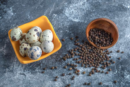 Bowl of quail eggs with black pepper seeds