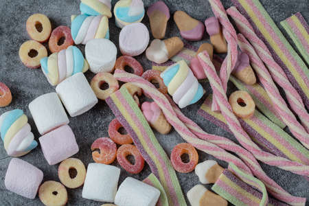 Mix of marshmallow and jellybeans on the marble background