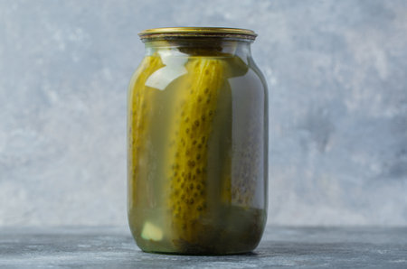 Close up photo of pickle jar on grey background.の写真素材