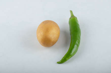 Fresh potato and green pepper on white backgroundの写真素材