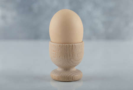 Close up photo of Boiled egg in eggcup on white backgroundの写真素材