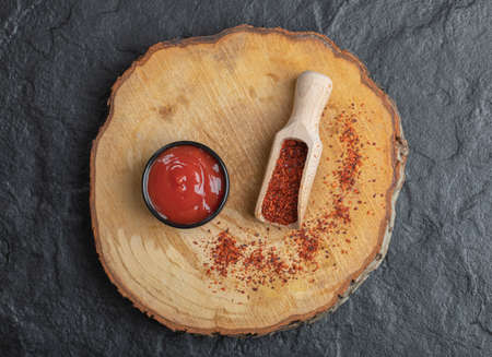 Top view of red hot chili pepper with ketchup on wooden boardの写真素材