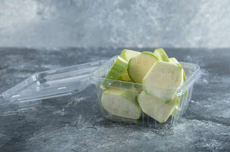 Close up photo of zucchini slices in plastic containerの写真素材