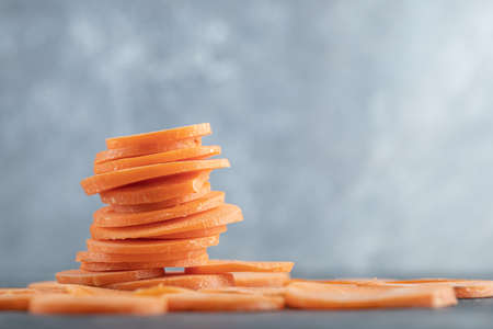 Close up photo of stack of carrot slicesの写真素材