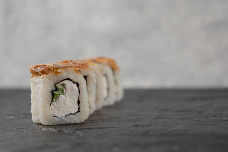 Tasty dragon sushi rolls with eel on black surfaceの写真素材