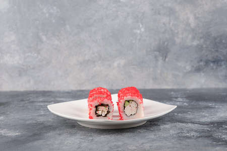 California rolls with flying fish caviar on white plateの写真素材