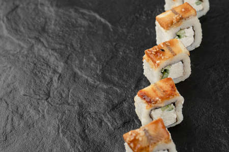 Tasty dragon sushi rolls with eel on black surfaceの写真素材