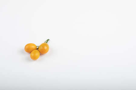 Ripe fresh kumquat fruits isolated on white backgroundの写真素材