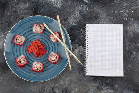 California sushi rolls and pickled ginger on blue plate