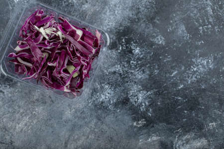 Top view of plastic container full with fresh chopped purple cabbage