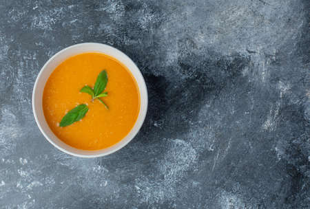 Delicious tomato soup in white bowl