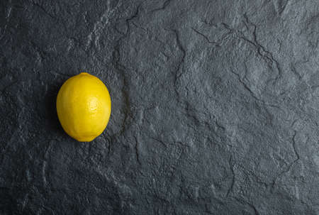 A single lemon on the black backgroundの写真素材