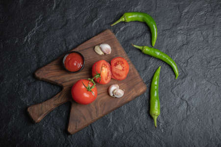 Wide angle photo of ripe tomatoes with garlic and ketchupの写真素材
