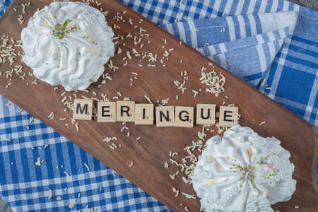 Meringue writing with wooden letter dices on the groundの写真素材