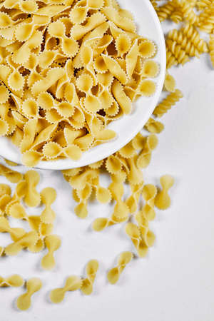 Uncooked pastas on white backgroundの写真素材