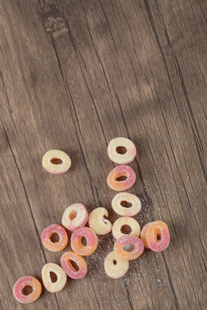 Red and yellow circle jellybeans on the wooden table