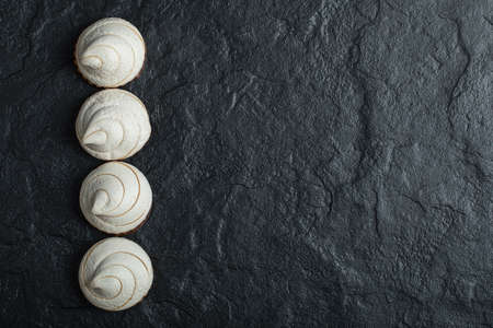 A line of delicious cupcakes on a dark backgroundの写真素材